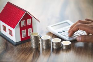 Mortgage concept by money house from the coins